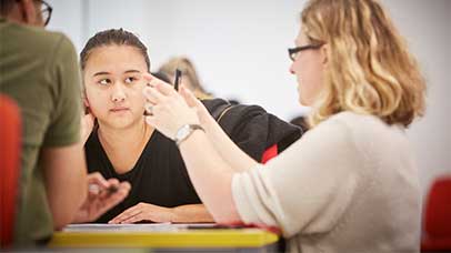a student and tutor discussing in class