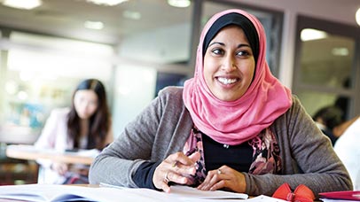 a postgraduate student studying in the library