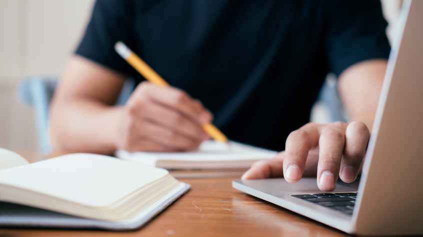 Man studying at a table.