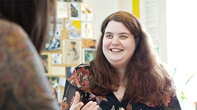 a teacher chatting to university staff