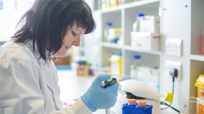 researcher in a lab using a pipette