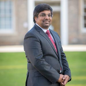 Professor NIshan Canagarajah standing in front of the Fielding Johnson building