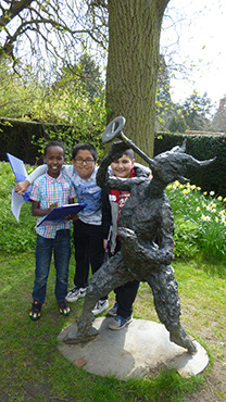 Children by Pan sculpture at the University of Leicester Botanic Garden