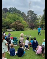 Crowd of young children watching a water rocket fire up outside in the Botanic Garden