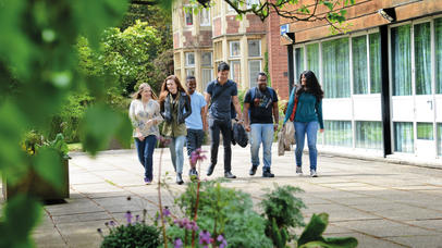 A diverse group of students walk outside