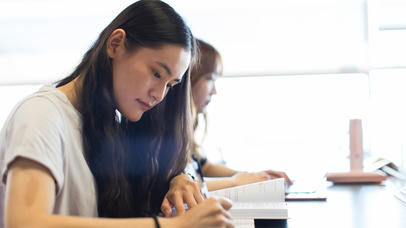 A student takes notes during class