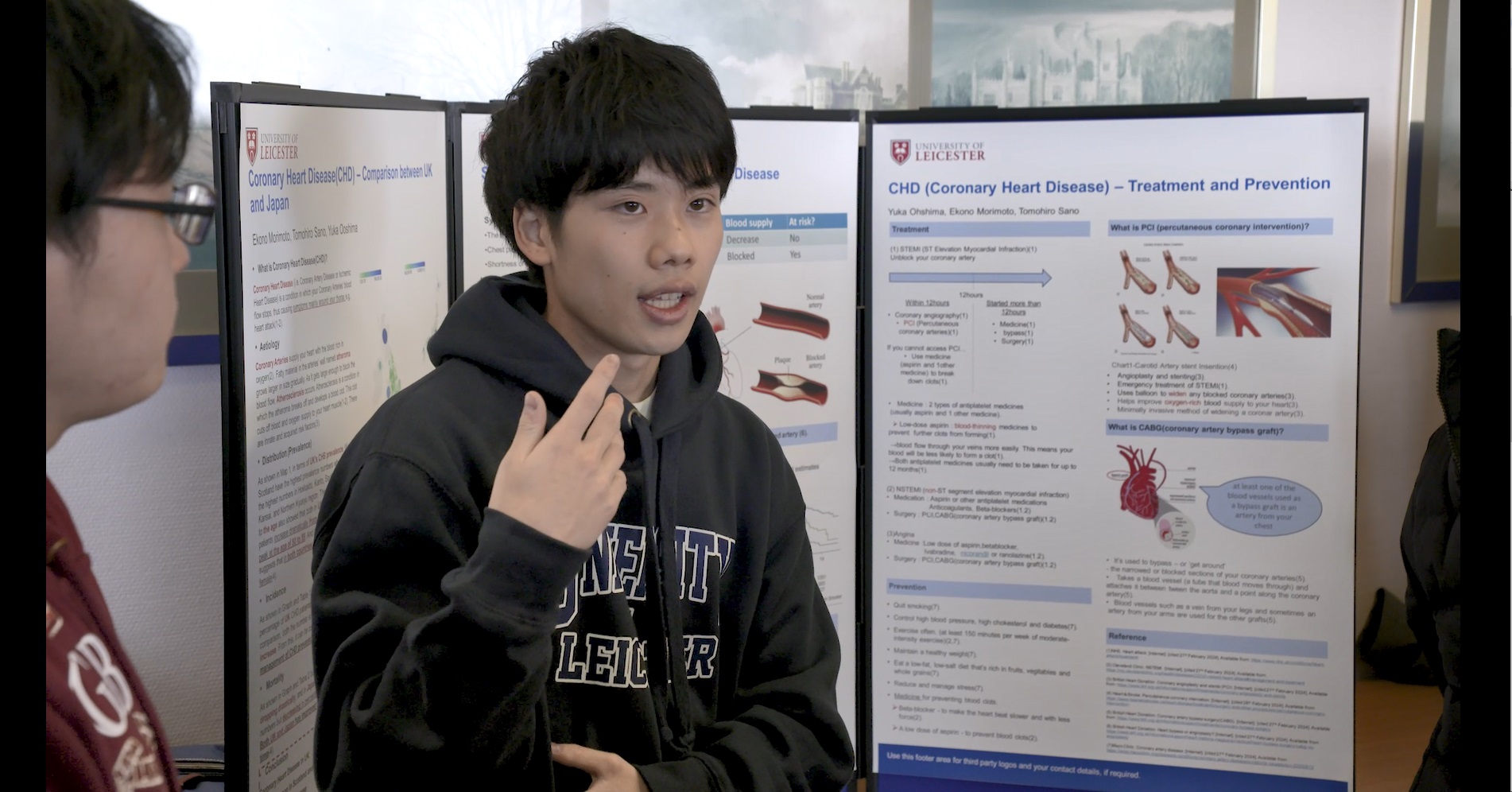An English for Medics student talks about his medical research in a poster presentation event.