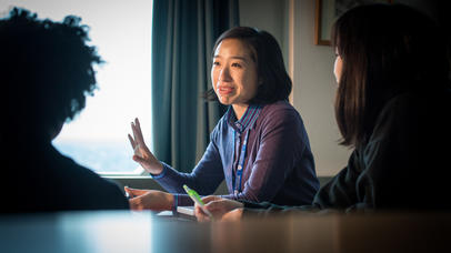 A female teacher gestures while teaching