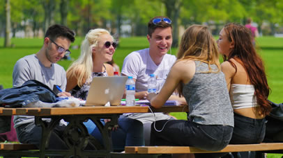 Student studying outside in the sunshine