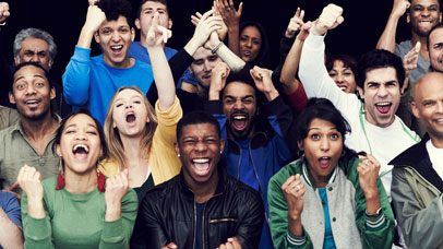 Group of people cheering and pumping the air with their fists.