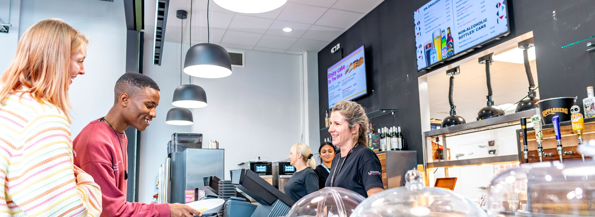 Students paying for food across a counter of a food outlet on Leicester campus.