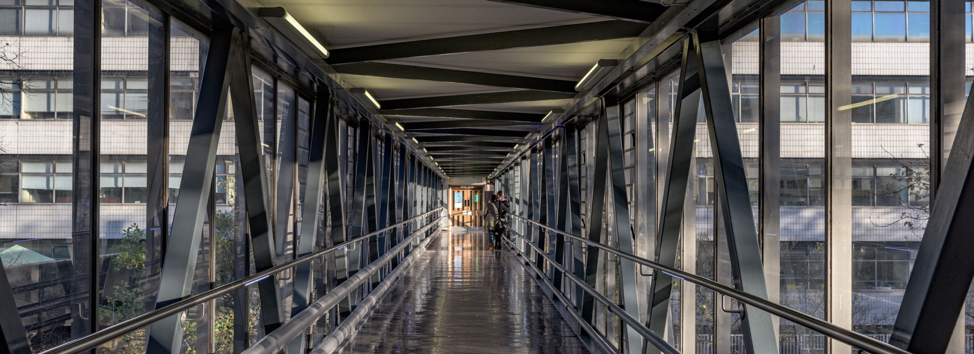 View of a covered walkway between buildings on Leicester campus.