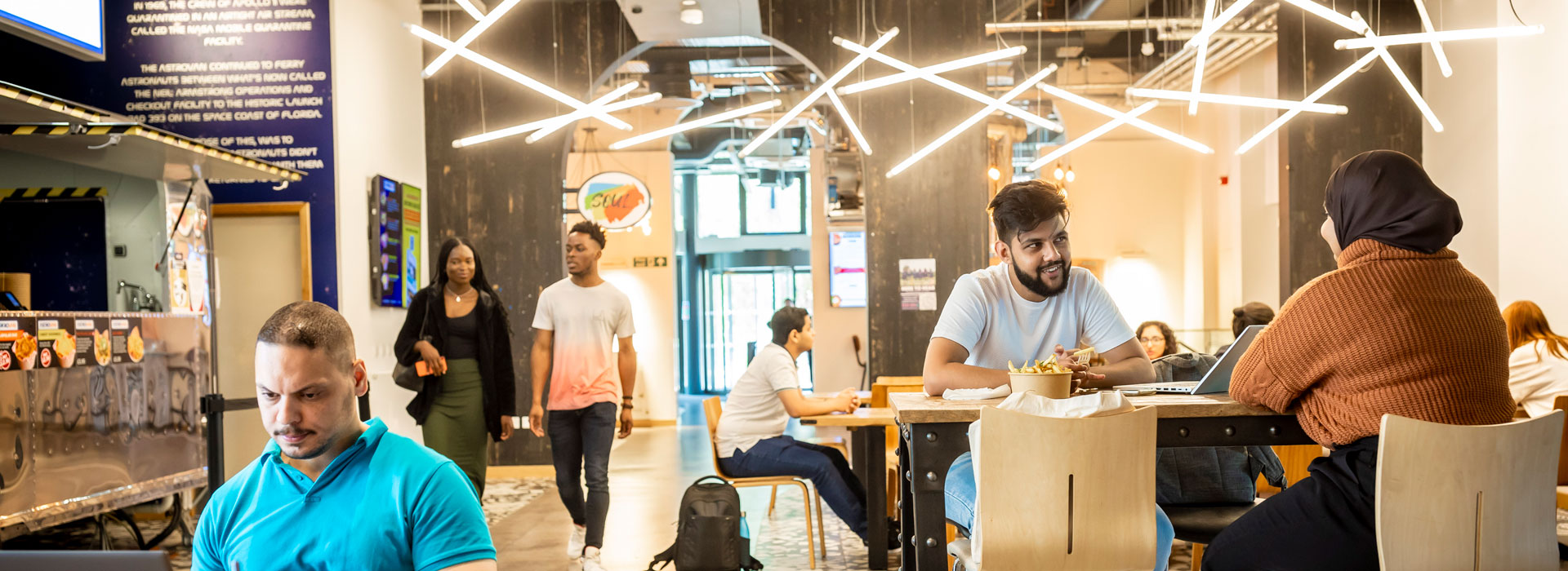 Students milling around the food outlets in the Students' Union building.