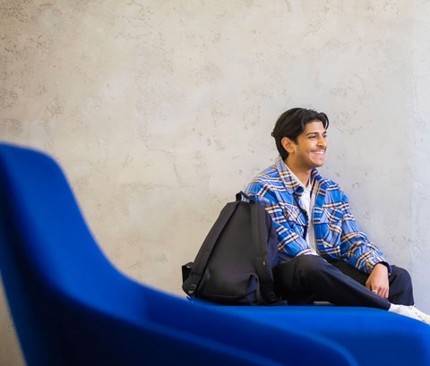 Students sitting and chatting in a common area on Leicester campus.