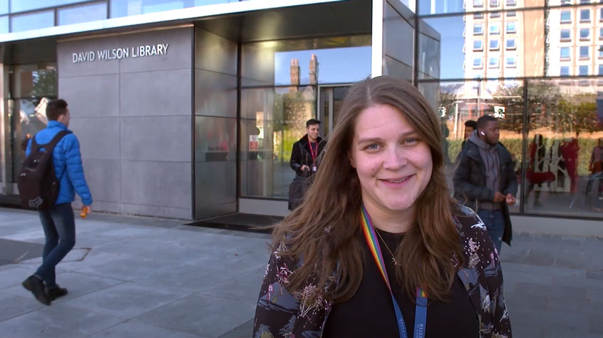 Hannah Congrave standing in front of the University of Leicester library
