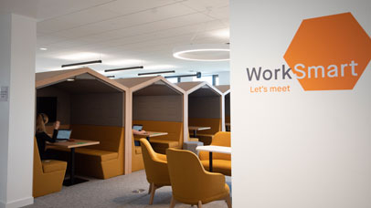 A bank of desks in a shared working area on Leicester campus.