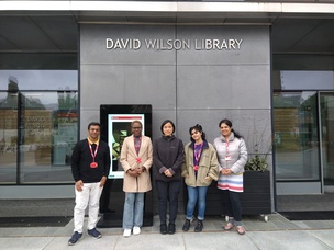 Group of five people standing outside David Wilson Library building