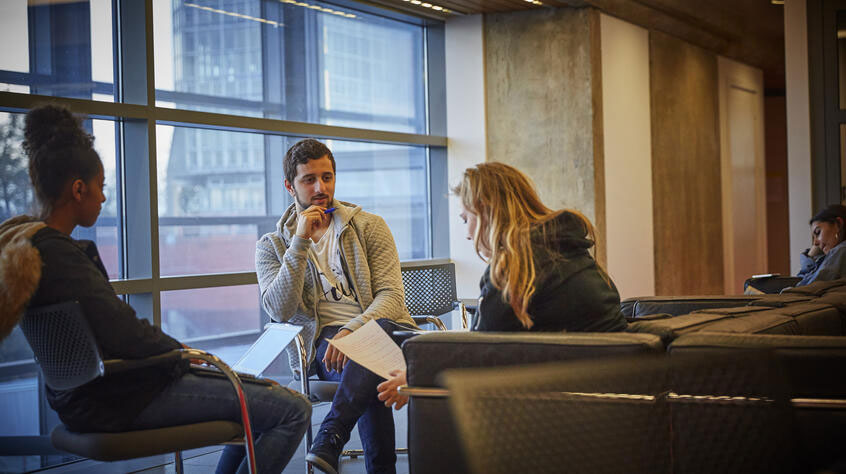 Students sitting and talking in the David Wilson Library.