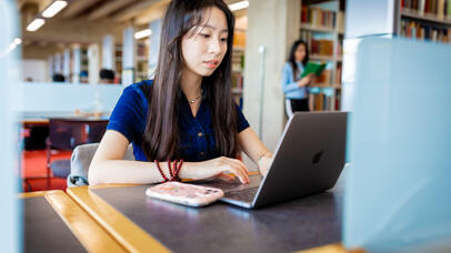 student working on laptop in the library 