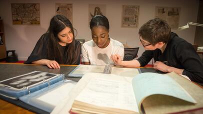 Three people looking at archives in Special Collections
