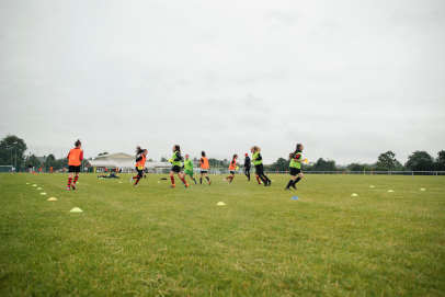 Female student footballers on playing field