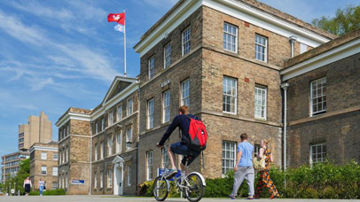 Students walking and cycling past the Fielding Johnson building