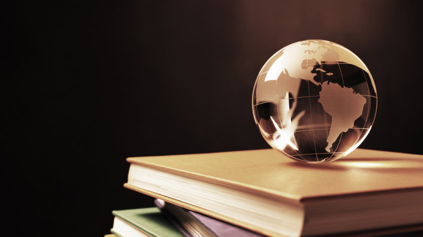glass globe on a stack of books
