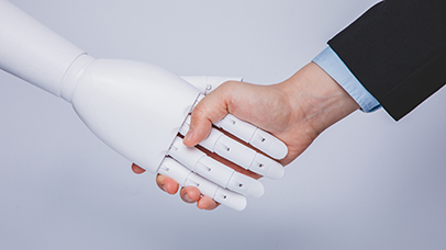 Robot hand shaking a man's hand