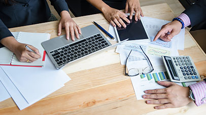 People working in a team on a desk.