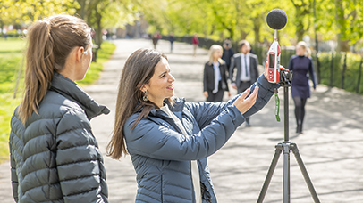 Two members of the CEHS team measuring noise levels outside