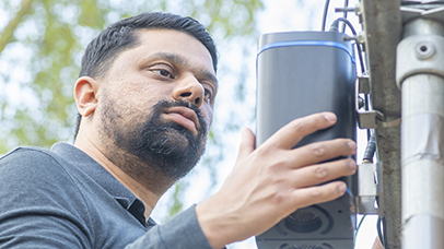 A CEHS team member adjusts equipment for detecting pollution levels