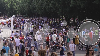 A crowd of people outside with noise level overlay displays placed upon different groups