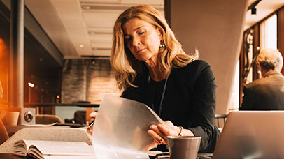Woman researching using books.