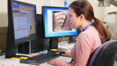 Woman uses computer to research.