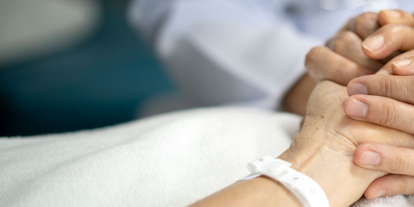 Doctor clasping a patient's hand