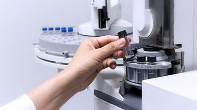 Scientist picking up a vial