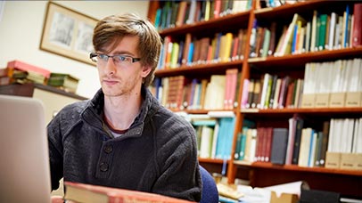 student researching on a laptop