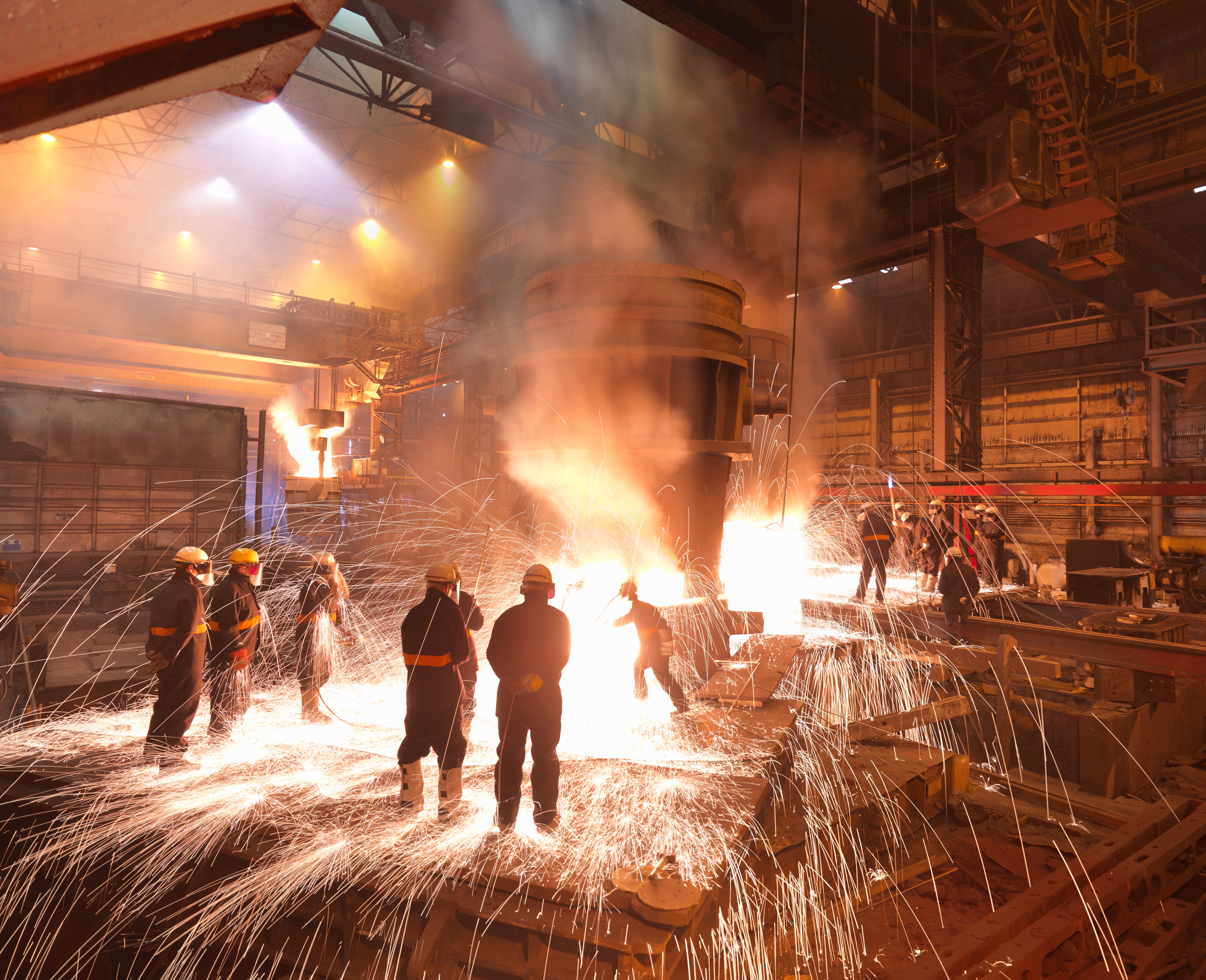 Workers with molten steel in a plant