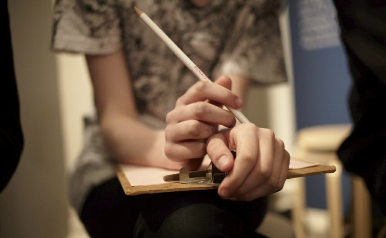 Hands holding a clipboard