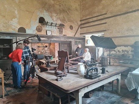 A group of people filming on location at Calke Abbey