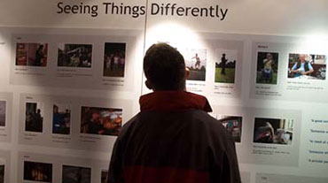 A person viewing an exhibition about disability