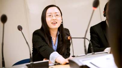 staff member speaking into a microphone