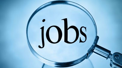 The word 'jobs' magnified by a magnifying glass,