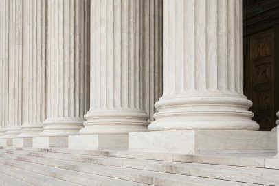 Steps and large white pillars leading to a court house
