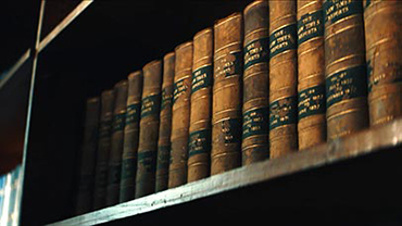 Old bound books on a bookcase
