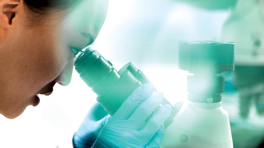 Scientist looking in a microscope