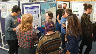 participants gathered around posters on display boards.