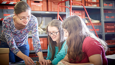 Group of three women sitting together and looking at some research