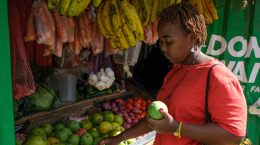 Woman picking fruits in a market