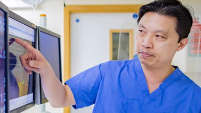 A doctor looking at a monitor
